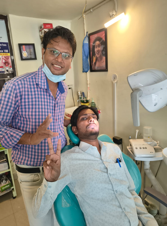Smiling patient with Dr. Sanjiv Kumar after successful treatment